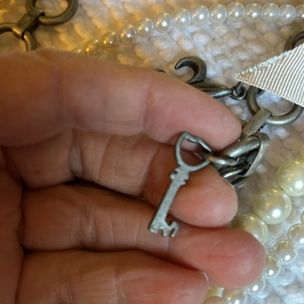 Women’s double chain belt. One of metal objects and the second chain of pearls.